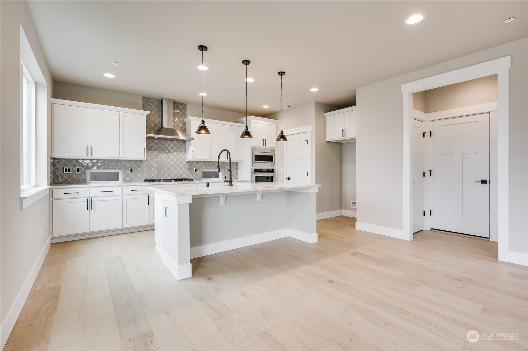 4439 244th Street Southeast Bothell, WA 98021 - Photo 11 of 29 a large white kitchen with a white cabinets