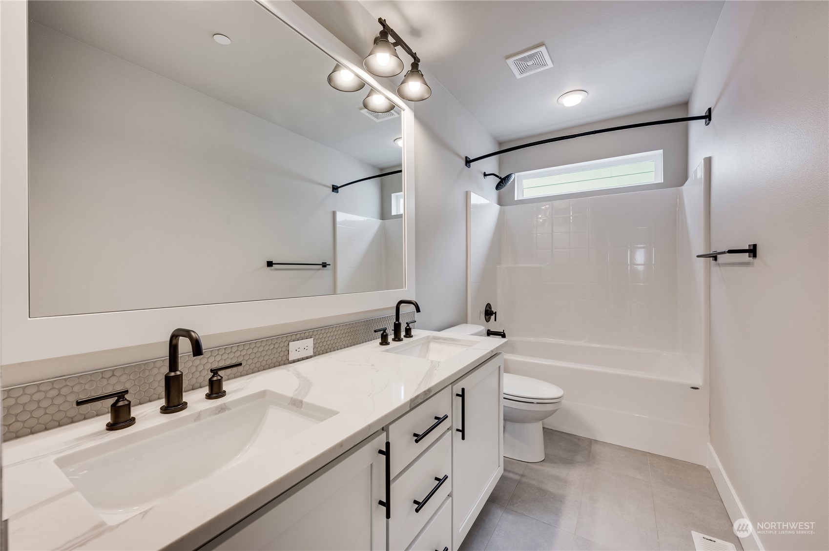 4439 244th Street Southeast Bothell, WA 98021 - Photo 18 of 29 a bathroom with a double vanity sink toilet mirror and shower