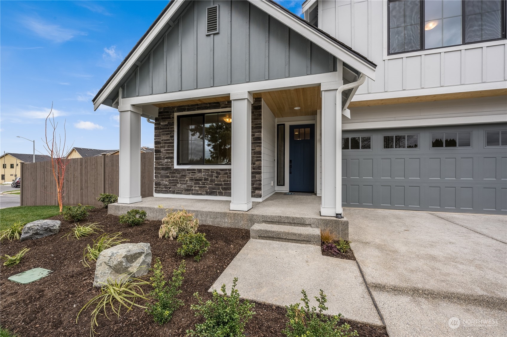 4439 244th Street Southeast Bothell, WA 98021 - Photo 3 of 29 a front view of a house with a garden