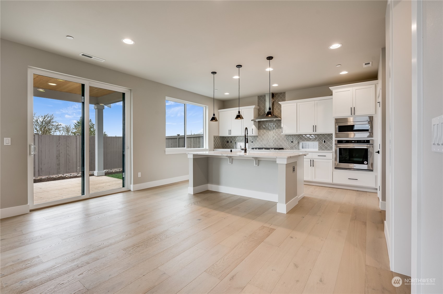4439 244th Street Southeast Bothell, WA 98021 - Photo 10 of 29 a large white kitchen with stainless steel appliances kitchen island a stove a refrigerator and cabinets