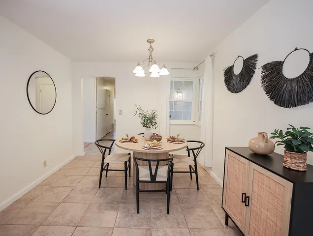 a dining room with wooden table and chairs