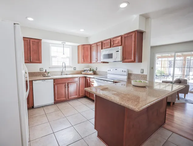 a kitchen with stainless steel appliances granite countertop a sink counter space cabinets and a window