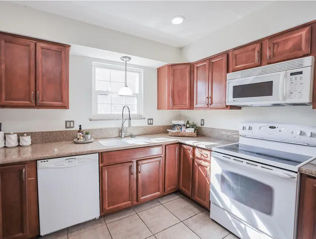 a kitchen with stainless steel appliances granite countertop a sink stove and microwave