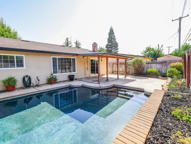 a view of a patio with chairs and a table
