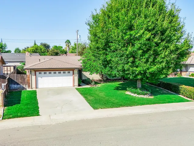 an aerial view of residential houses with greenery