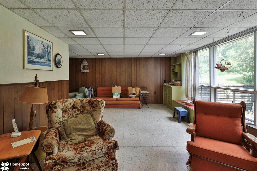 6054 Old Hickory Road Coopersburg, PA 18036 - Photo 26 of 48 Wood paneling and expansive windows define this versatile lower-level living area.