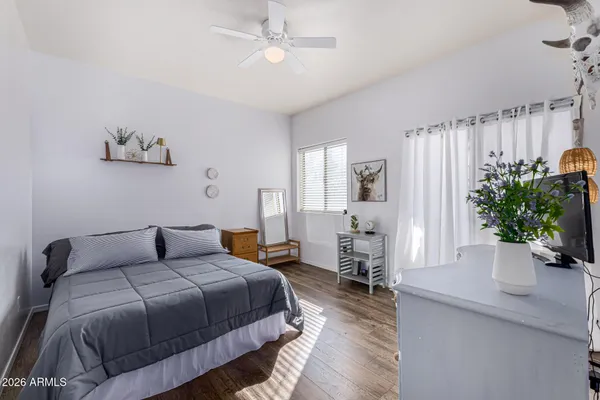 a bedroom with a large bed and a potted plant