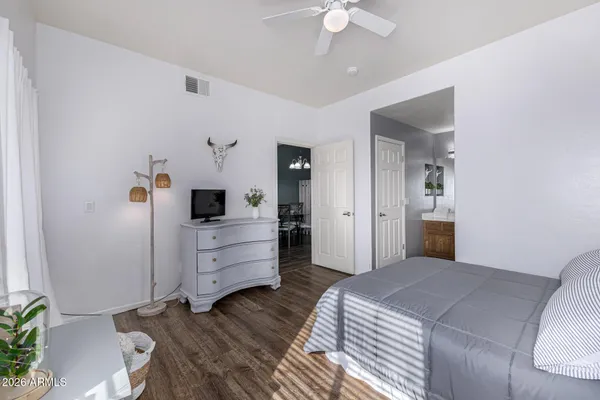 a bedroom with a bed and a chandelier