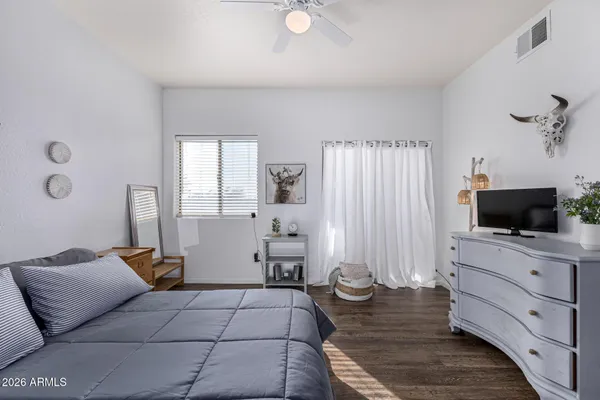 a bedroom with furniture and a flat screen tv