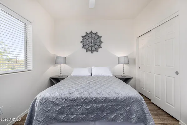 a bedroom with a bed and a lamp