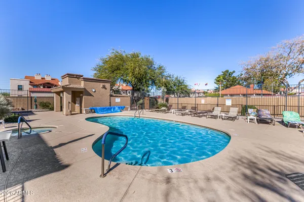 a view of a swimming pool with a lounge chair