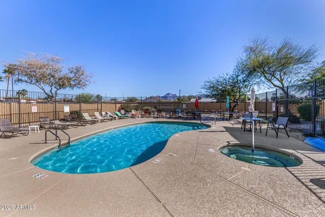 a view of a swimming pool with outdoor seating