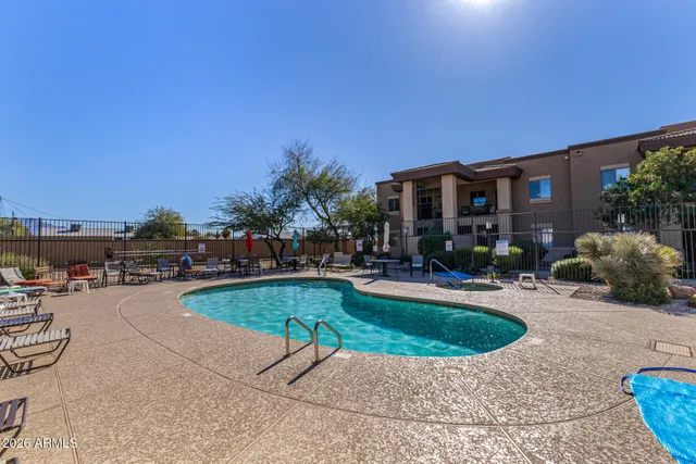 a view of a swimming pool and lounge chairs