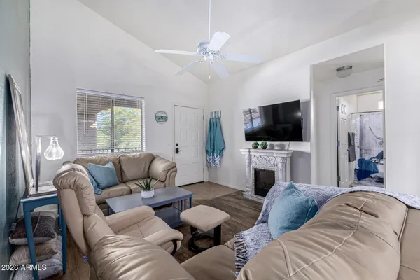 a living room with furniture a fireplace and a flat screen tv