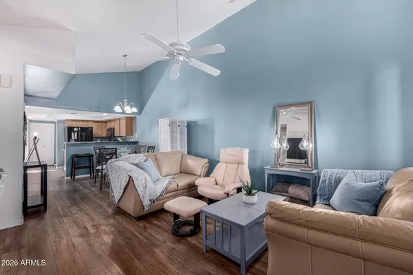 a living room with furniture and a wooden floor