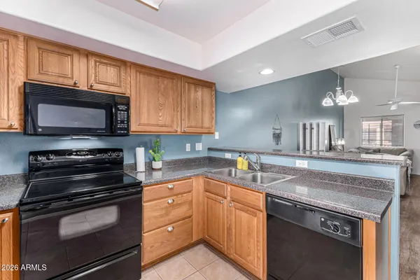 a kitchen with a sink stove and microwave