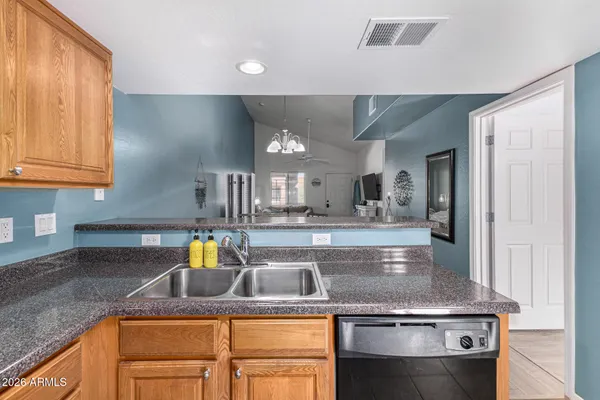 a kitchen with stainless steel appliances granite countertop a sink a stove and a refrigerator