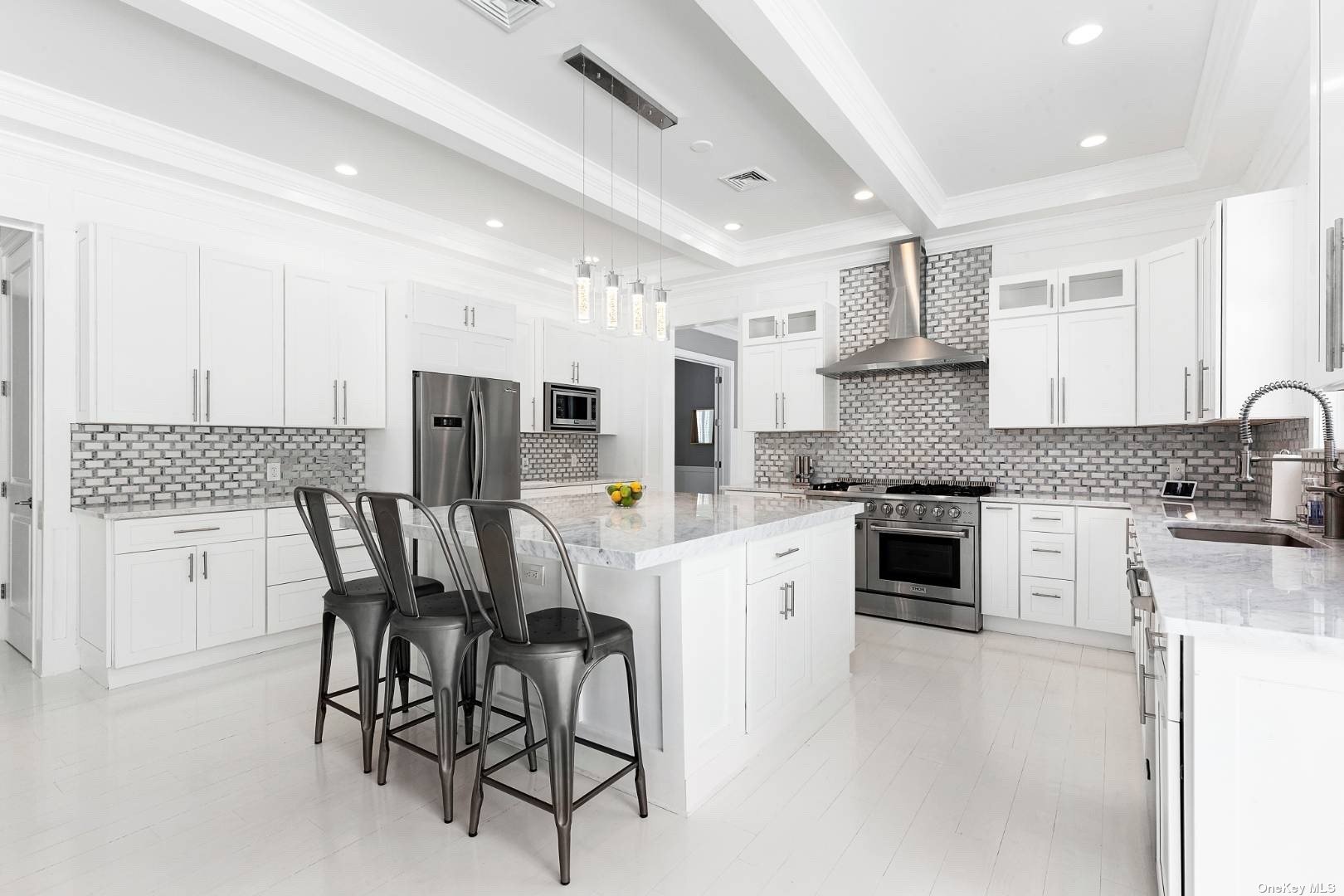 2 Westhampton, undefined 00000 - Photo 9 of 31 a kitchen with stainless steel appliances kitchen island granite countertop a table chairs sink and cabinets