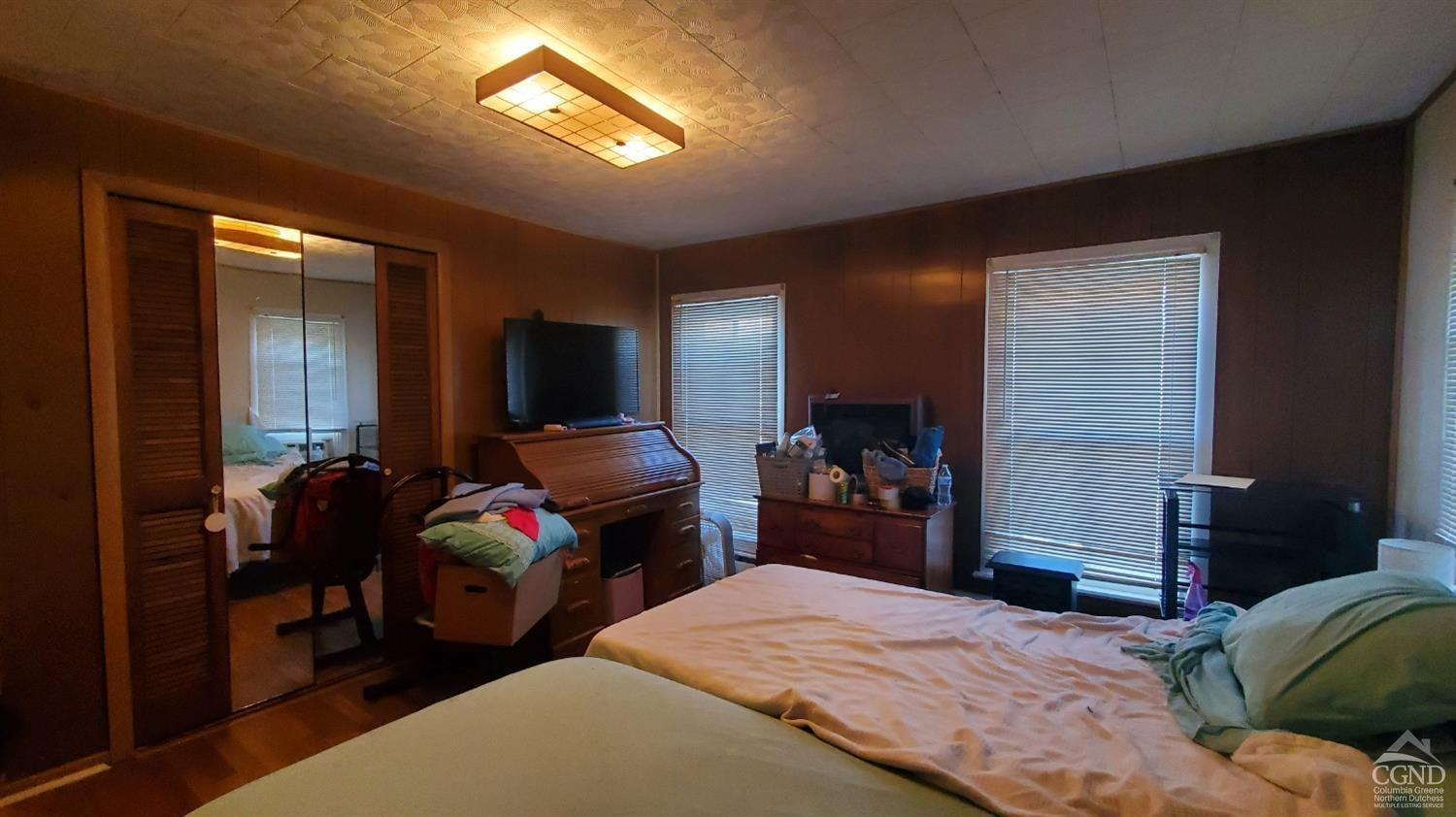 109 Summit Avenue Catskill, NY 12414 - Photo 7 of 12 a bedroom with a bed and a tv on dresser