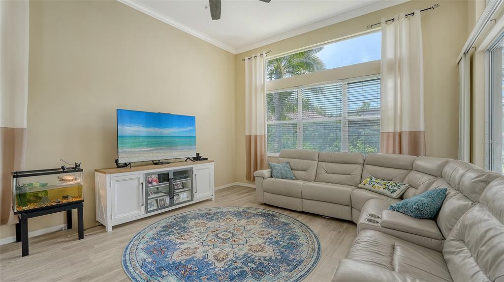 7717 US Open Loop Lakewood Ranch, FL 34202 - Photo 16 of 95 a living room with furniture and a flat screen tv