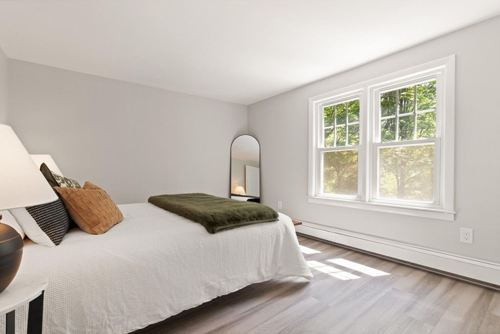 1049 Pleasant Street Canton, MA 02021 - Photo 9 of 16 a bedroom with a bed and wooden floor