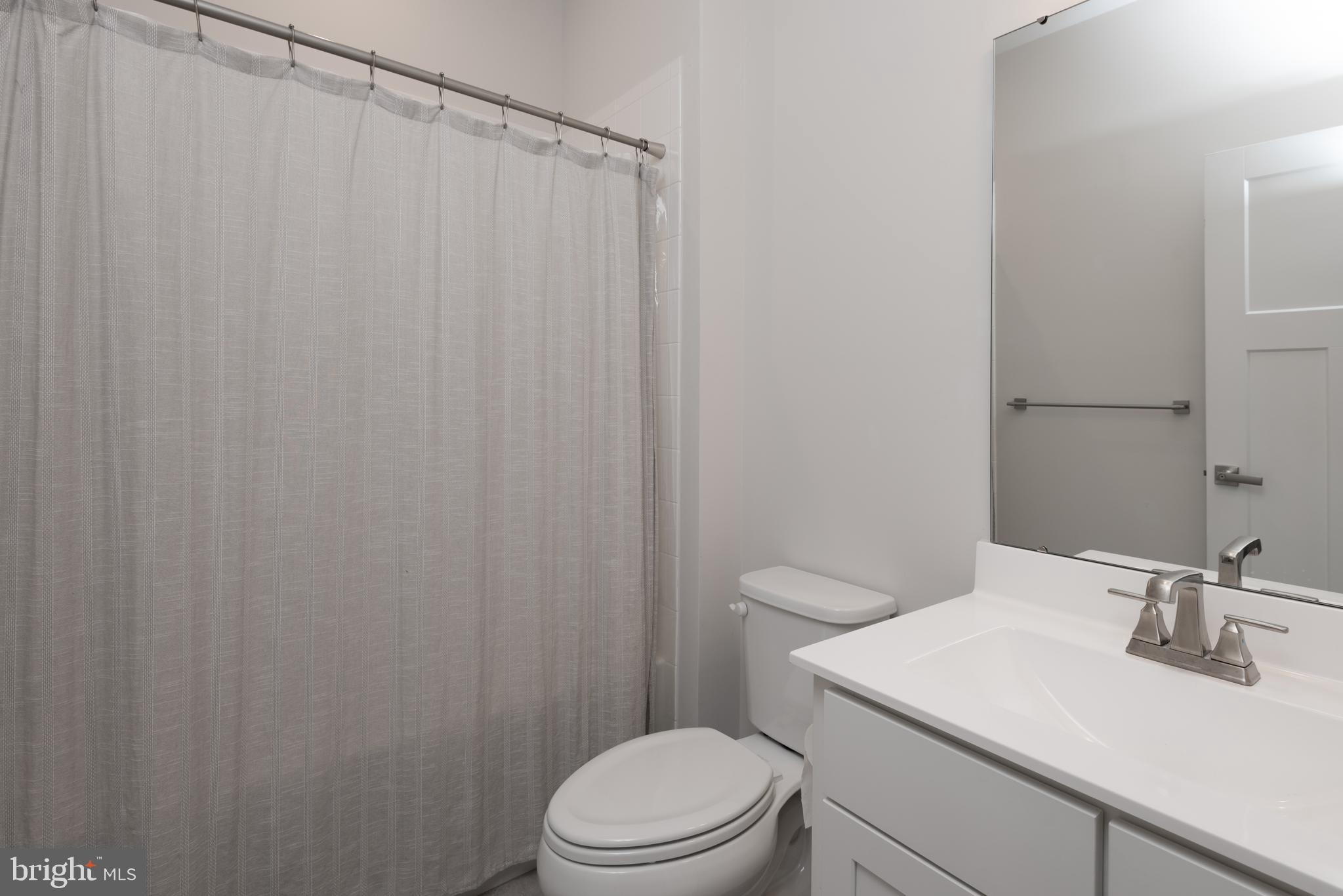 627 Quarry Point Road Malvern, PA 19355 - Photo 20 of 24 a bathroom with a sink a toilet and shower curtain