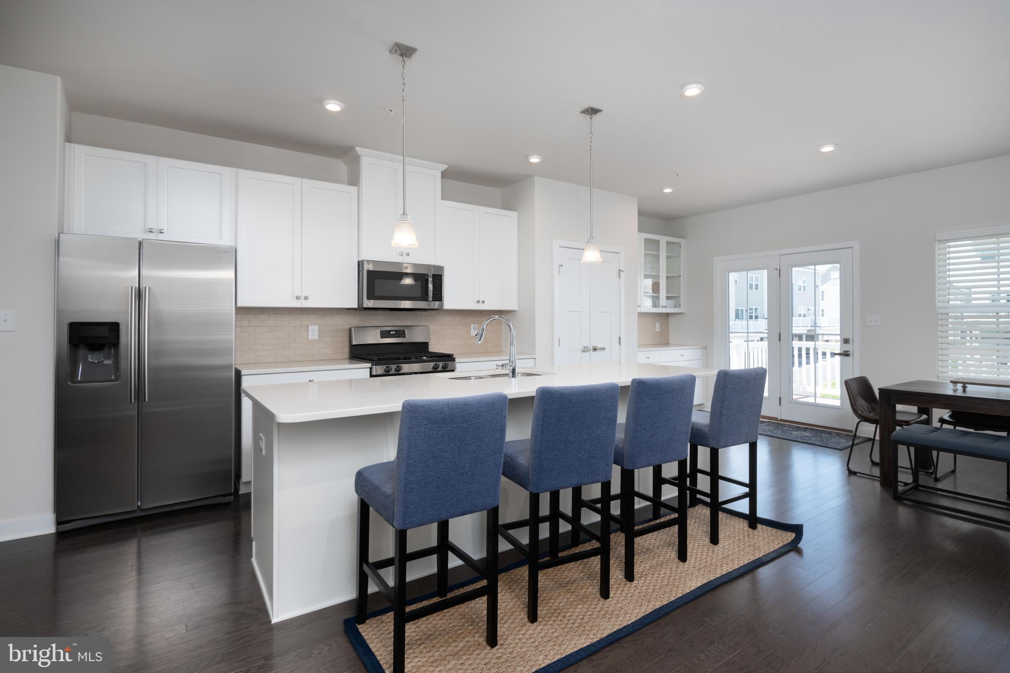 627 Quarry Point Road Malvern, PA 19355 - Photo 9 of 24 a kitchen with stainless steel appliances granite countertop a dining table chairs refrigerator and sink