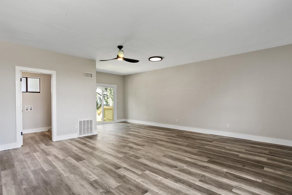 137 Mays Cove Road East Palatka, FL 32131 - Photo 15 of 70 a view of an empty room with window and wooden floor
