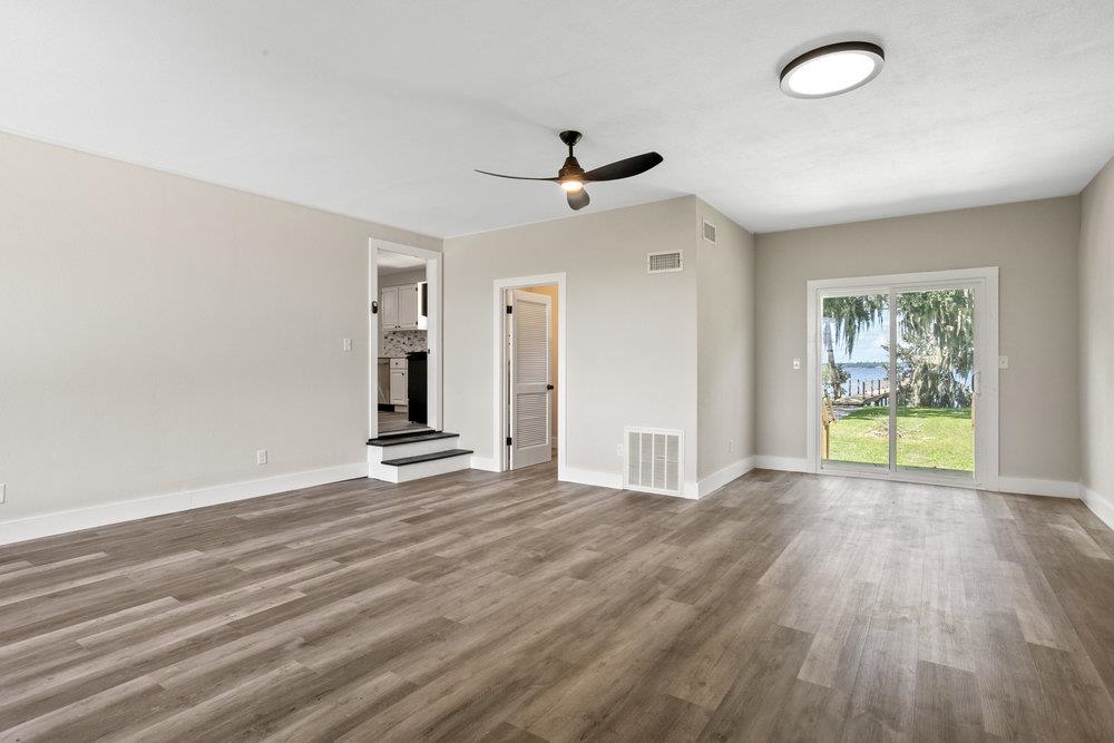 137 Mays Cove Road East Palatka, FL 32131 - Photo 16 of 70 wooden floor in an empty room with a window