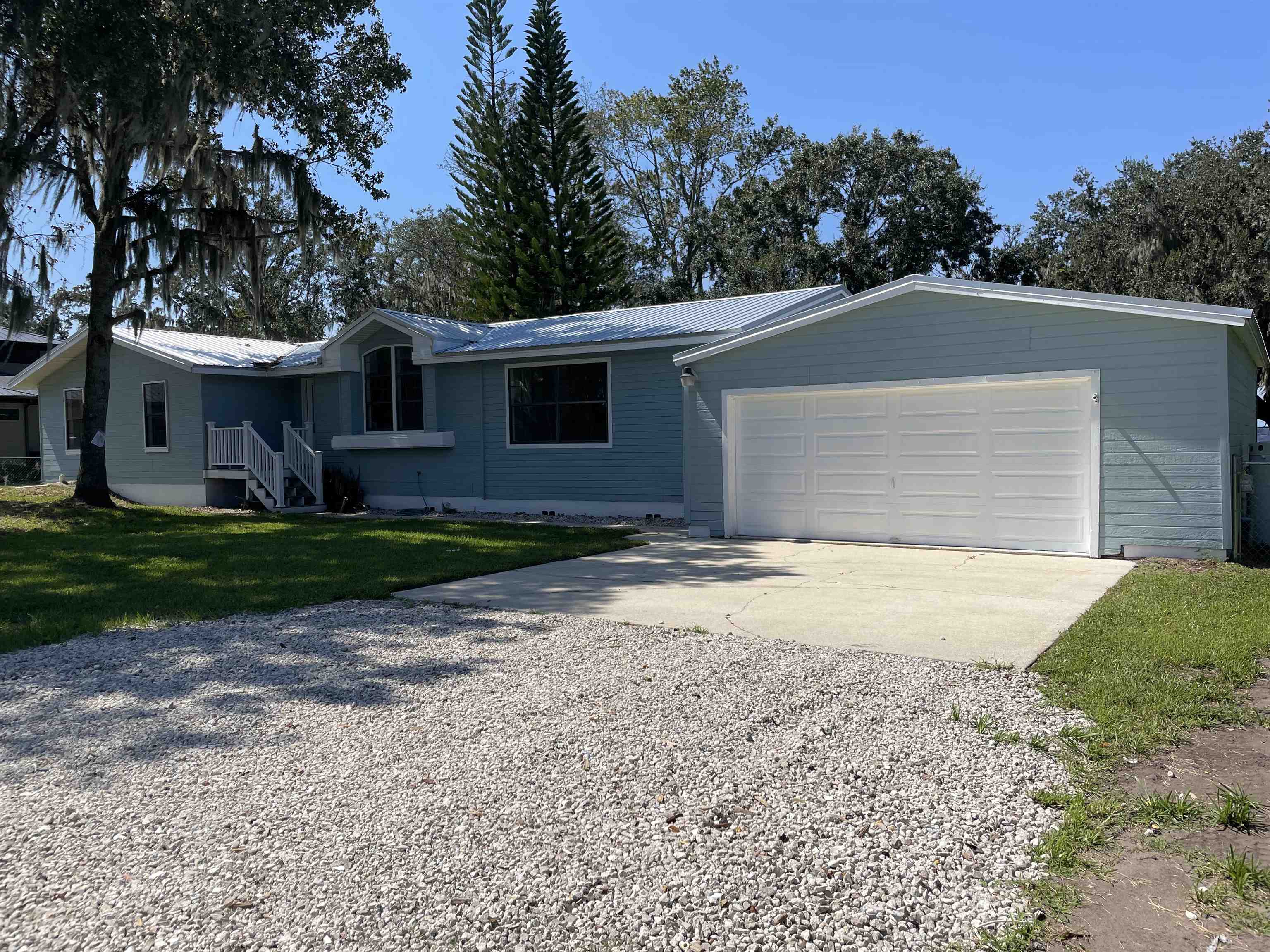 137 Mays Cove Road East Palatka, FL 32131 - Photo 2 of 70 a view of a yard in front of a house with large trees
