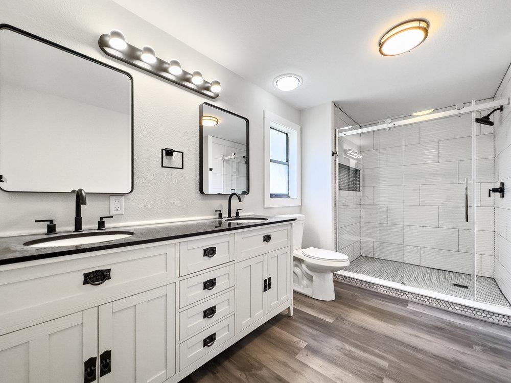 137 Mays Cove Road East Palatka, FL 32131 - Photo 31 of 70 a bathroom with a double vanity sink a toilet and a mirror