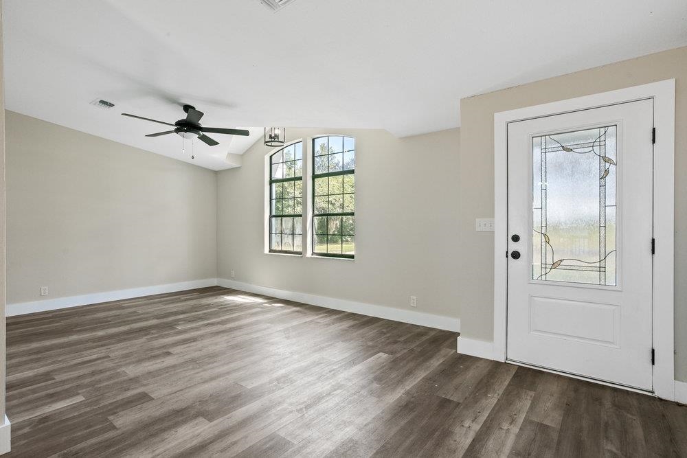 137 Mays Cove Road East Palatka, FL 32131 - Photo 6 of 70 wooden floor in an empty room with a window