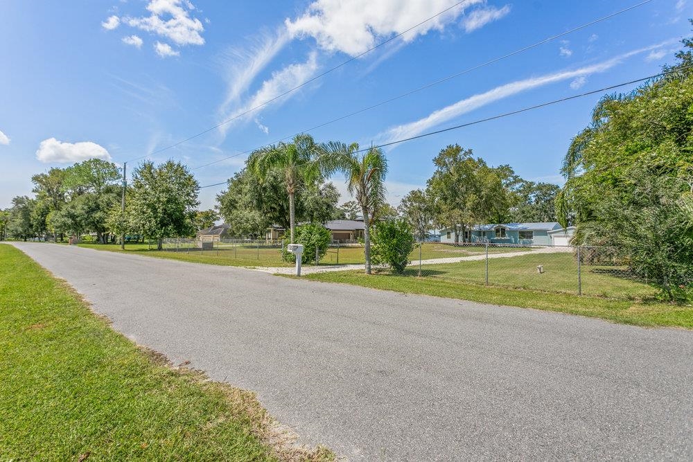 137 Mays Cove Road East Palatka, FL 32131 - Photo 65 of 70 a view of a house with a big yard and palm trees