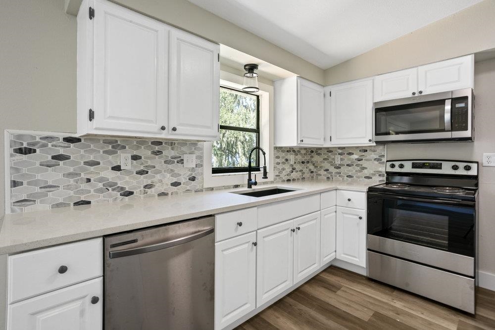 137 Mays Cove Road East Palatka, FL 32131 - Photo 10 of 70 a kitchen with granite countertop white cabinets stainless steel appliances and a sink