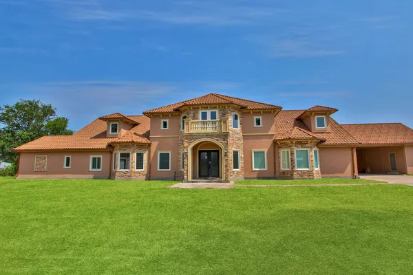 a front view of a house with a garden