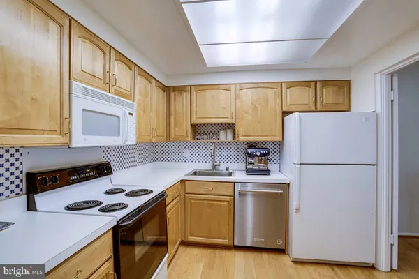 a kitchen with a stove a sink and a refrigerator