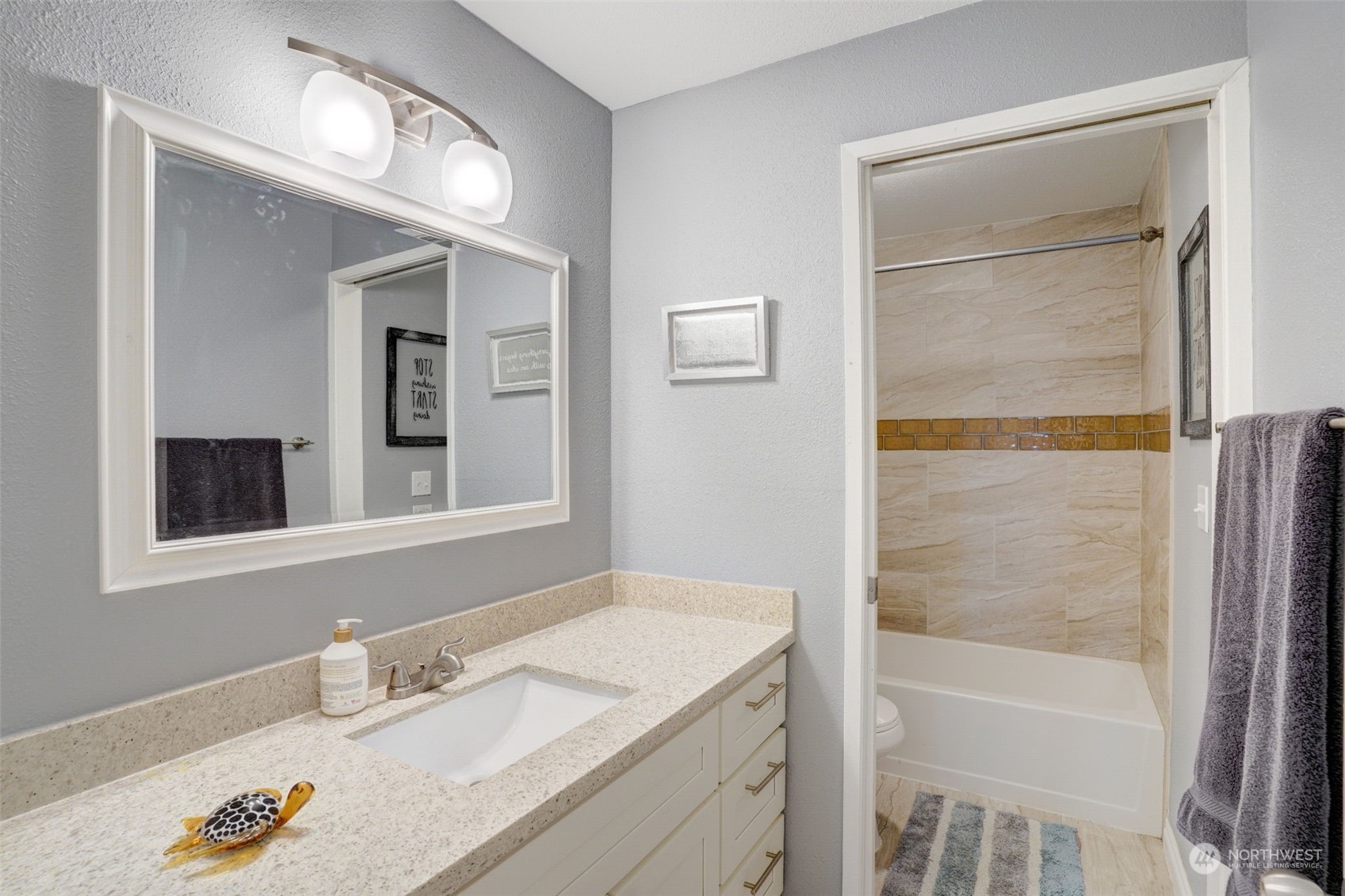 968 Brookdale Road East Tacoma, WA 98445 - Photo 20 of 31 a bathroom with a granite countertop sink a mirror and a shower