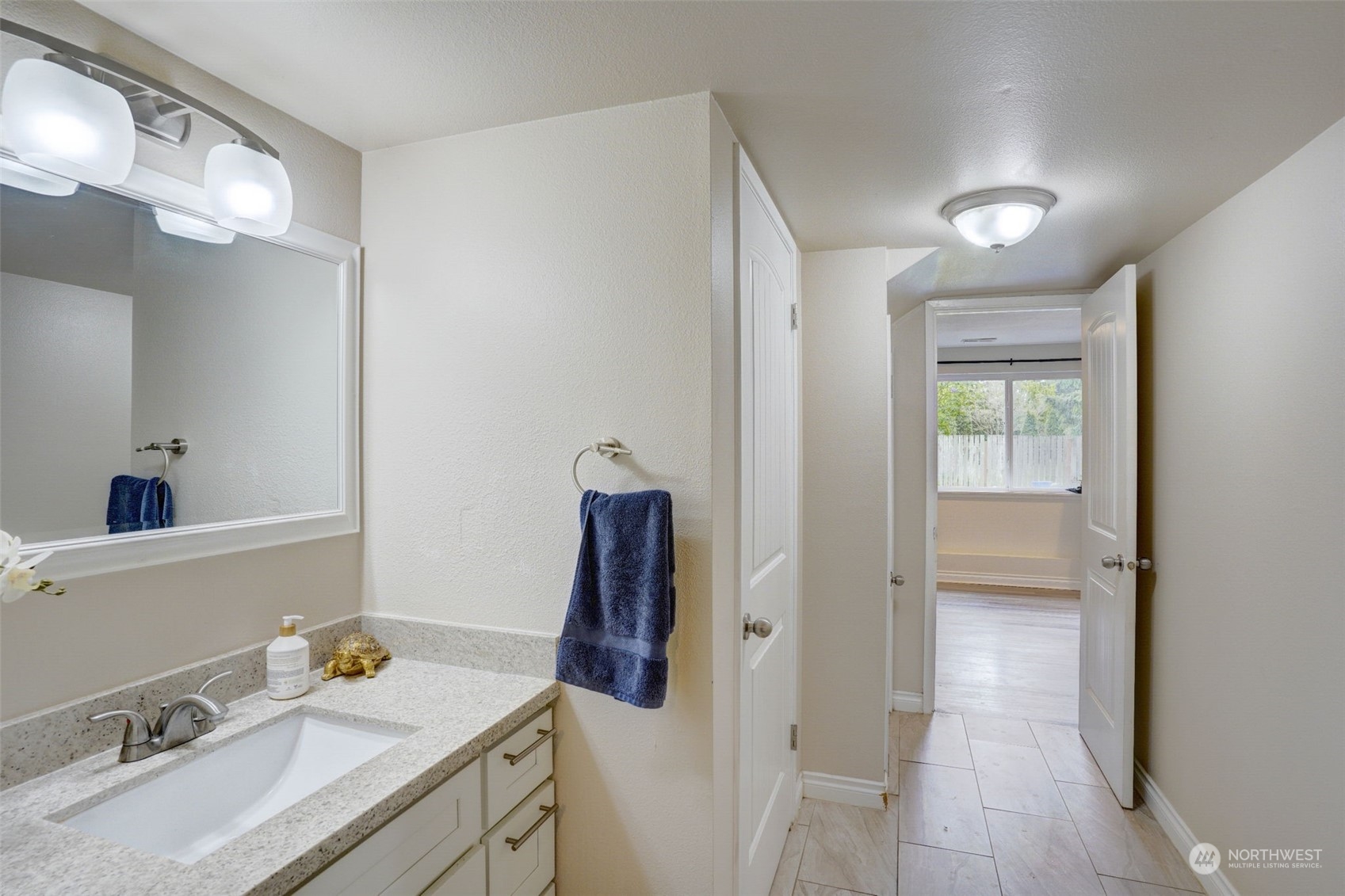 968 Brookdale Road East Tacoma, WA 98445 - Photo 23 of 31 a en suite bathroom with a sink vanity and mirror