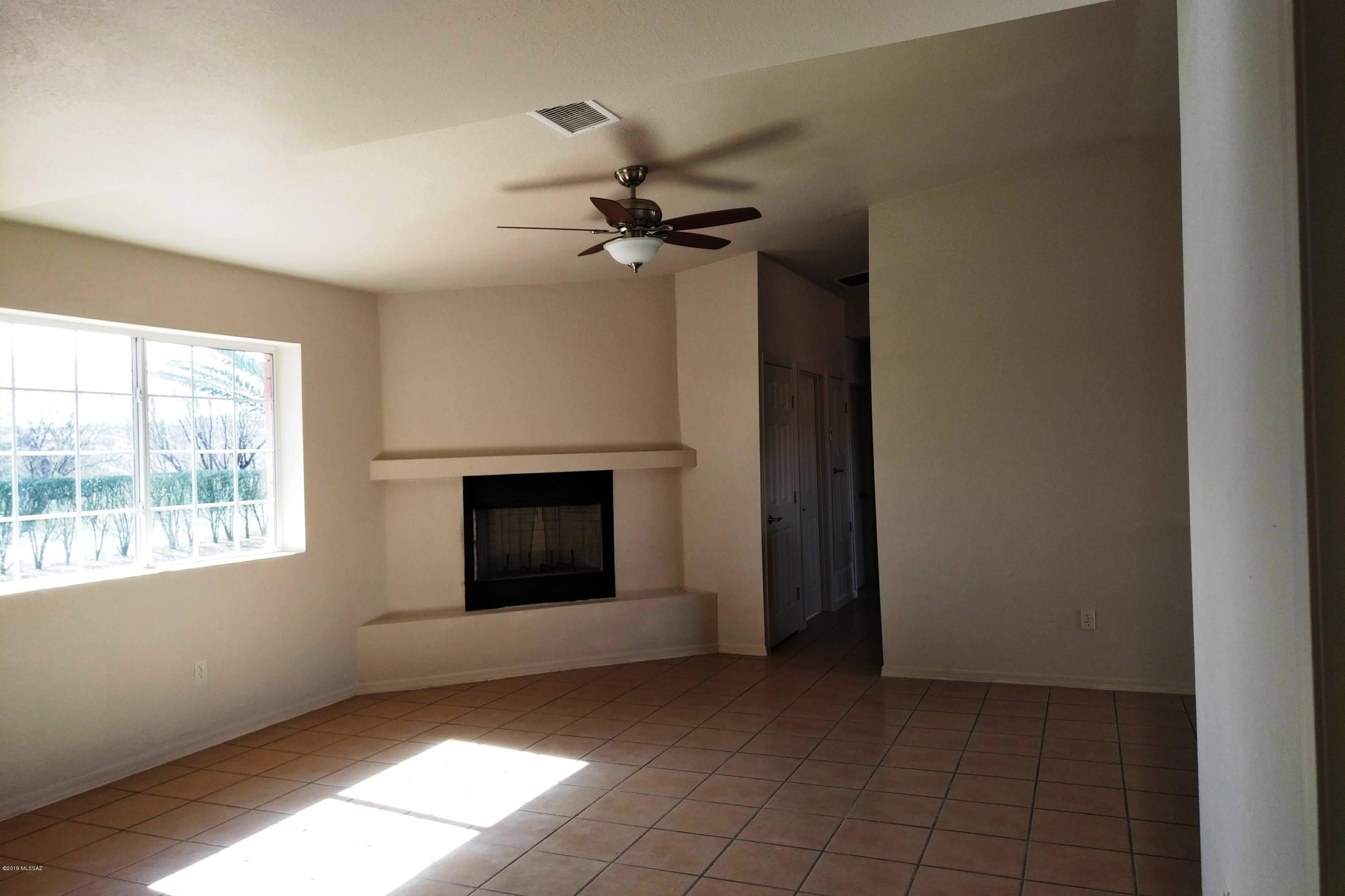 266 Mirto Court Rio Rico, AZ 85648 - Photo 8 of 22 an empty room with windows and fan