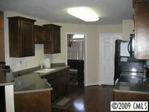 4430 Plyler Mill Road Monroe, NC 28112 - Photo 5 of 8 a kitchen with a sink a refrigerator and a stove