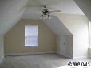 4430 Plyler Mill Road Monroe, NC 28112 - Photo 7 of 8 an empty room with a ceiling fan and window