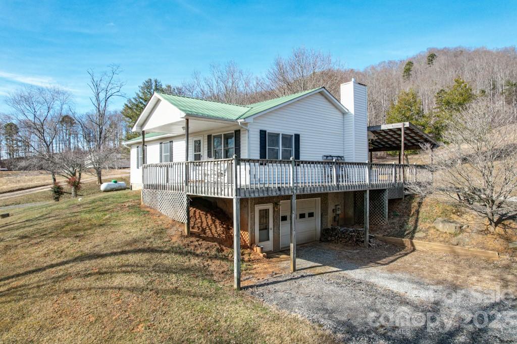 66 Fox Branch Road Fairview, NC 28730 - Photo 4 of 38 a view of a house with a balcony and yard