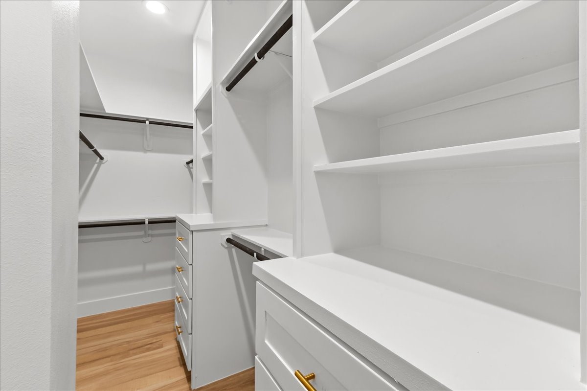 8323 Observatory Street, Unit A/B Houston, TX 77088 - Photo 11 of 38 Unit A - The spacious primary closet is thoughtfully designed with custom built-in shelving and drawer chests, providing ample storage and organization while adding a luxurious, boutique-style feel to your daily routine. Custom closet design may vary. Pictures are from a previous build.