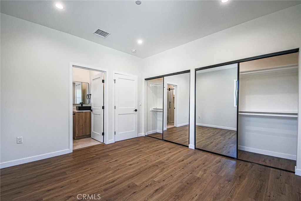 2129 Aaron Street, Unit 2 Los Angeles, CA 90026 - Photo 5 of 15 a view of an empty room with wooden floor and a bathroom