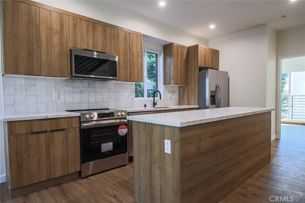 2129 Aaron Street, Unit 2 Los Angeles, CA 90026 - Photo 8 of 15 a kitchen with stainless steel appliances a stove microwave and refrigerator