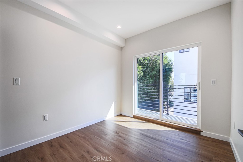 2129 Aaron Street, Unit 2 Los Angeles, CA 90026 - Photo 9 of 15 wooden floor in an empty room with a window