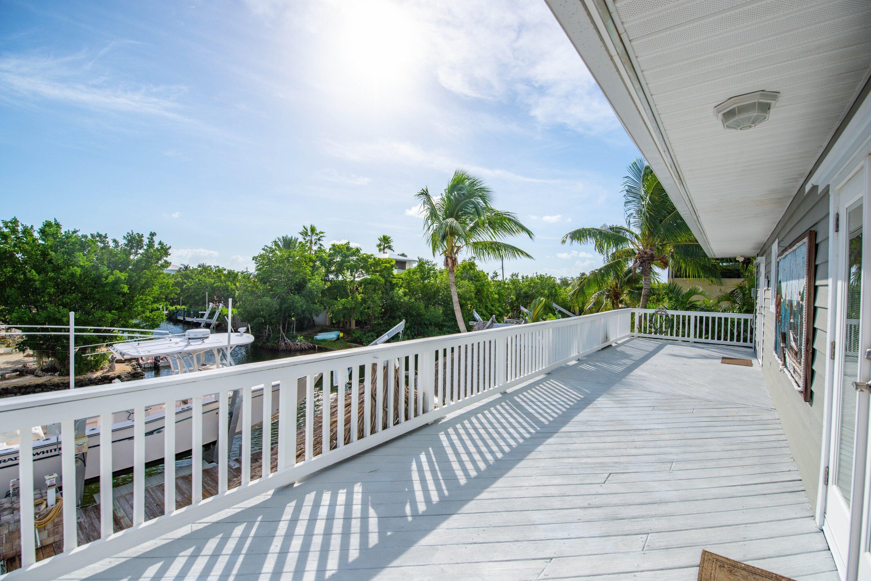 643 Indies Road Summerland Key, FL 33042 - Photo 18 of 50 a view of balcony with wooden floor and fence