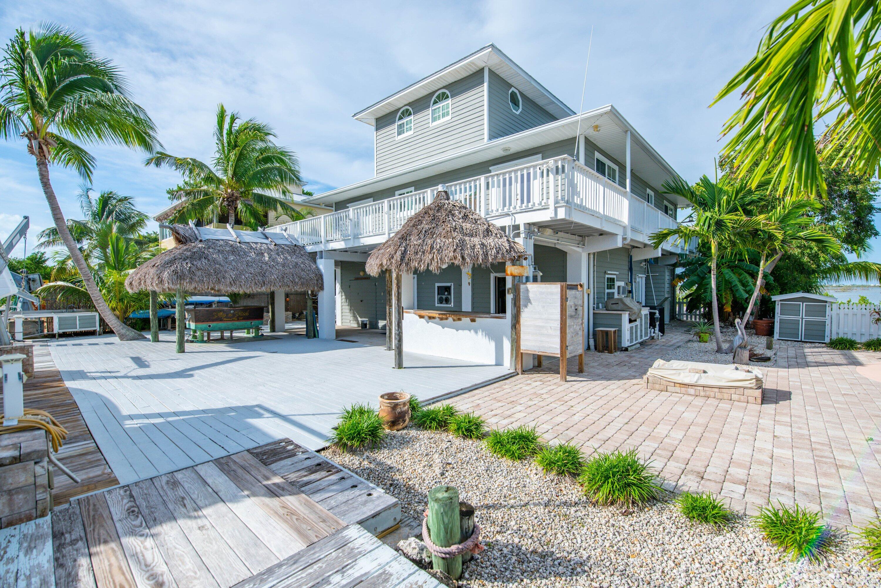 643 Indies Road Summerland Key, FL 33042 - Photo 22 of 50 a front view of a house with garden and porch
