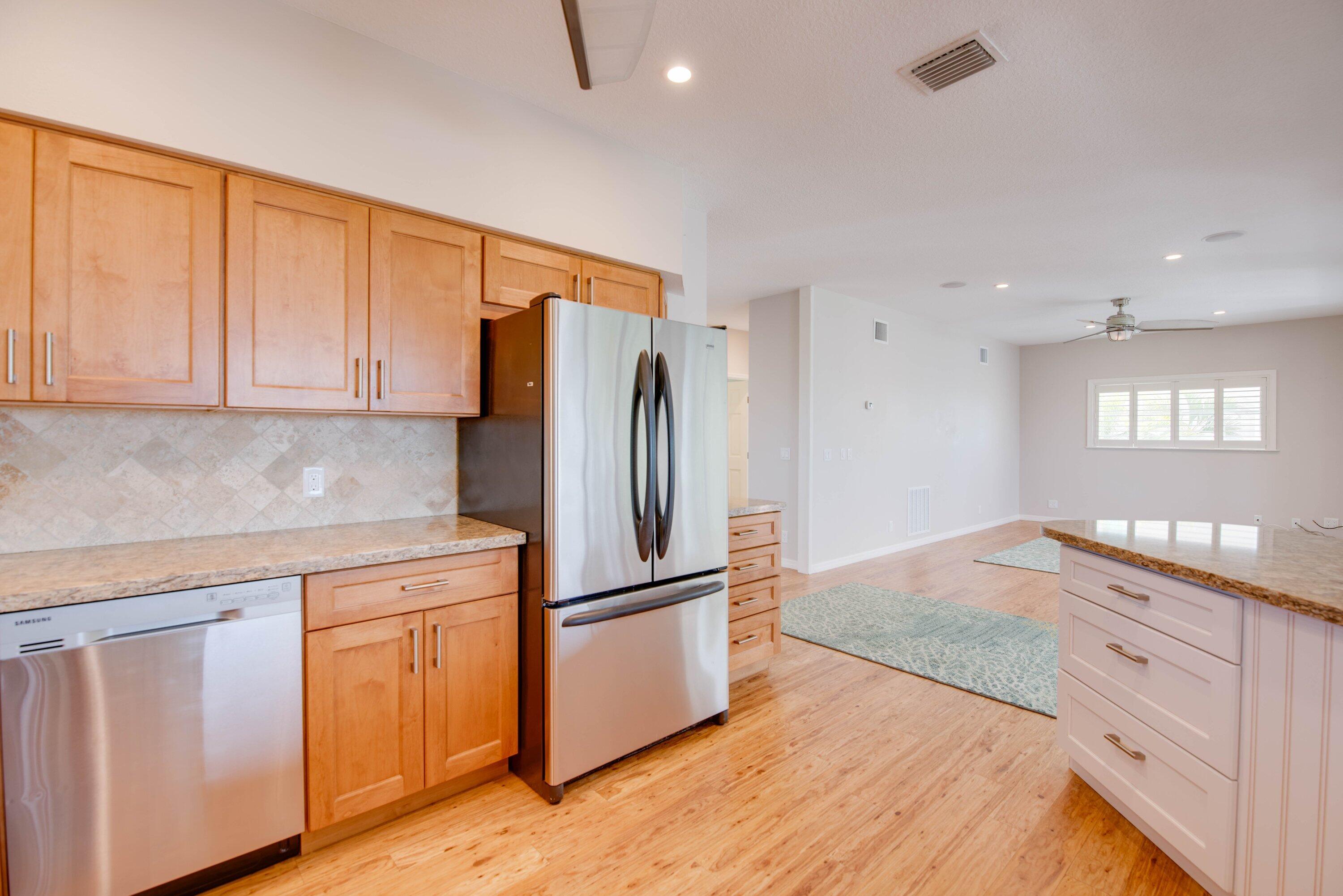 643 Indies Road Summerland Key, FL 33042 - Photo 28 of 50 a kitchen with white cabinets and stainless steel appliances