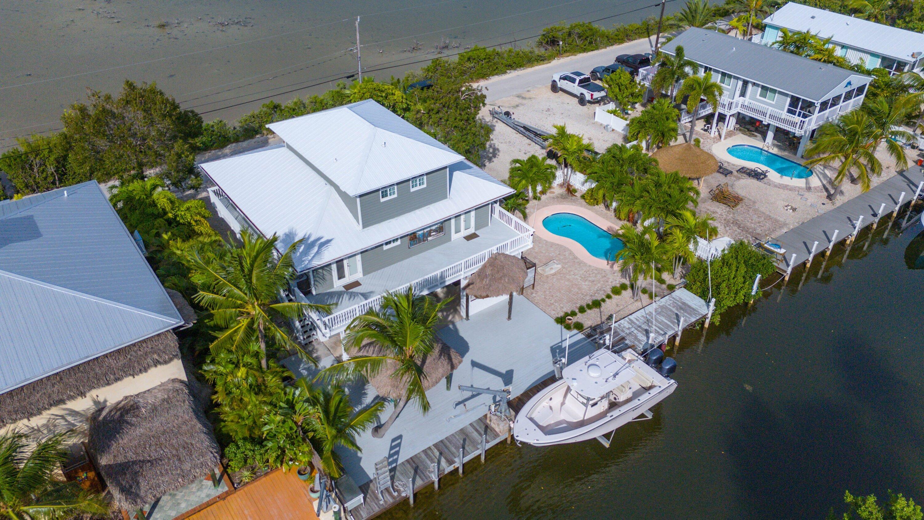 643 Indies Road Summerland Key, FL 33042 - Photo 29 of 50 an aerial view of a house with garden space and a swimming pool